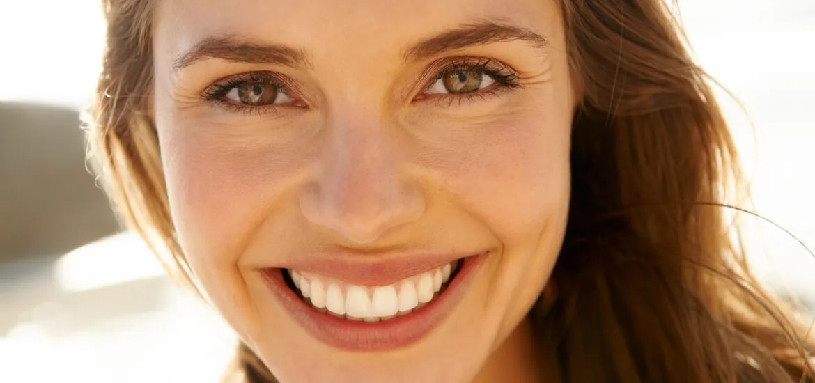 closeup of young woman with a perfect smile, cosmetic dentistry