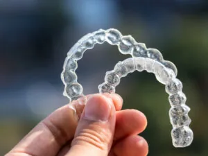 Fischer patient holding clear aligner trays from canyon lake cosmetic dentist