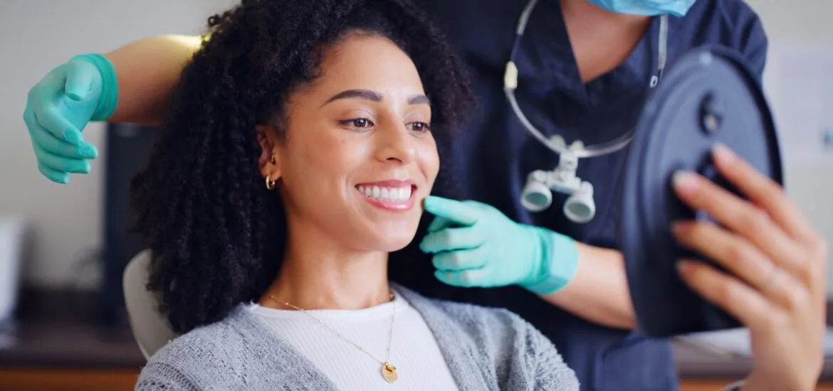 young woman smiling in a dental office, perfect white teeth