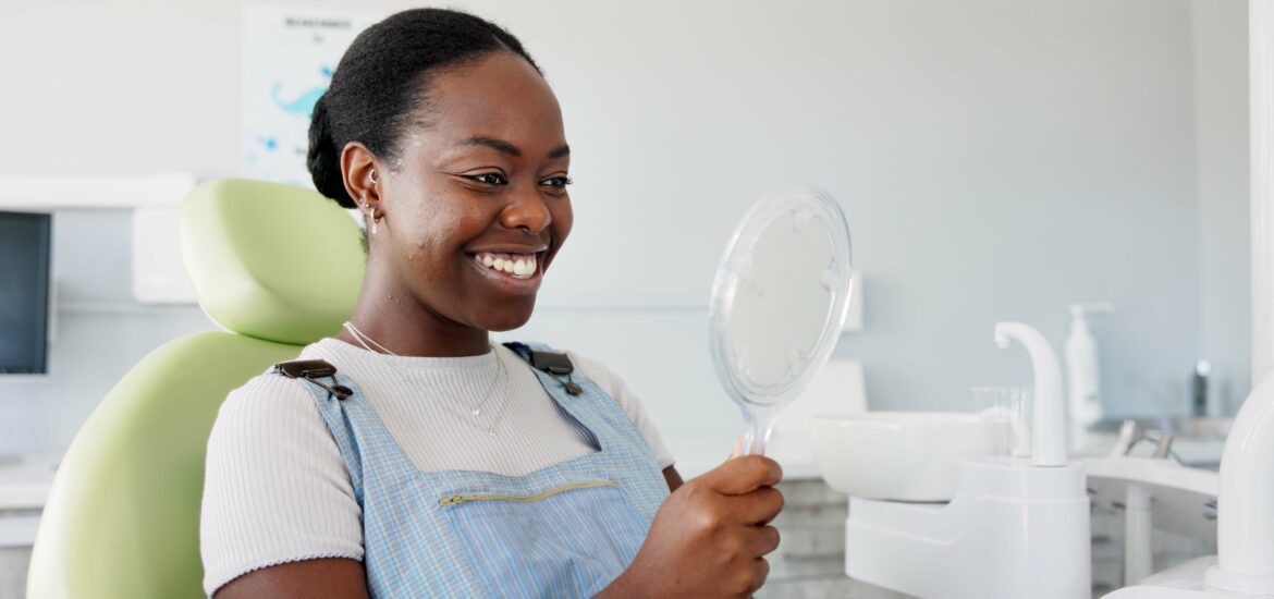 smiling woman in a dental chair, newly white teeth