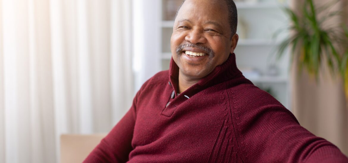 older man sitting on the couch, new veneers